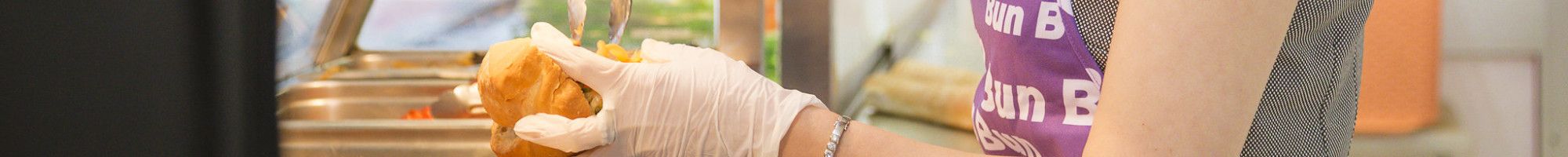 A lady preparing the Bánh Mì