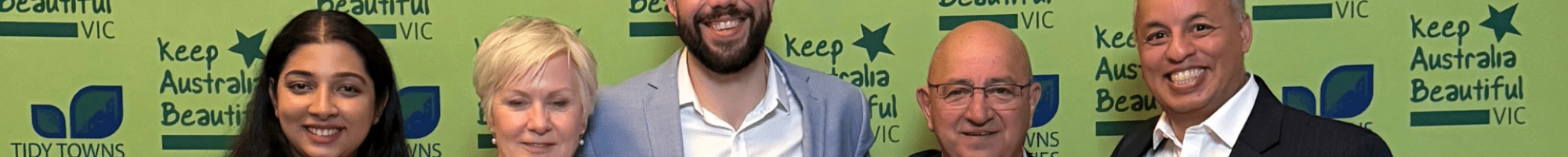 Waste team standing with award