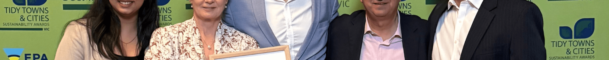 Waste team standing with award