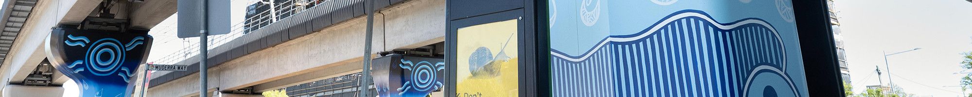 Muderra artwork on a concrete pole