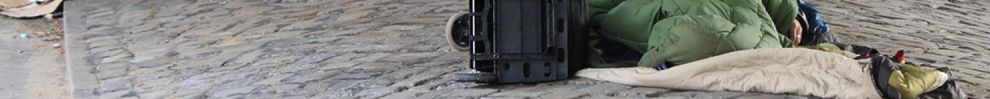 Someone sleeping on concrete