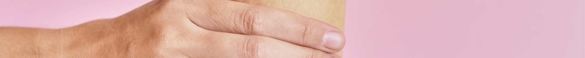 Hand holding a disposable coffee cup