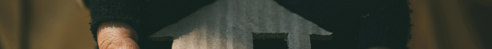 Close up of hands holding a crafted house
