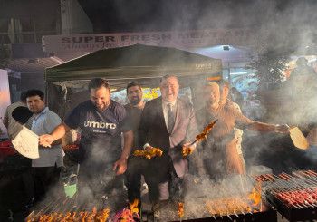 People enjoying cooking a barbecue.
