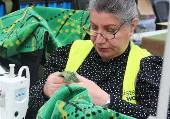 A women sewing at Sisterworks