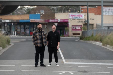 Artists Robert Michael Young and Koby Sainty standing in the middle of a road