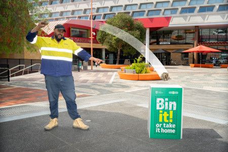 Man throwing rubbish in a bin