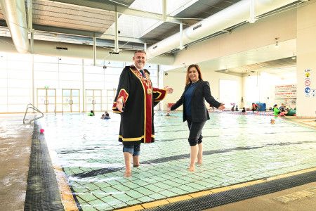Mayor Cr Jim Memeti and Deputy Mayor Cr Sophie Tan in a swimming pool
