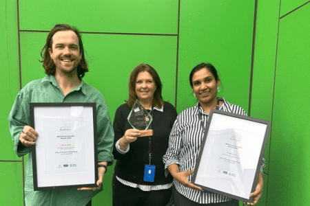 Staff members holding up the award