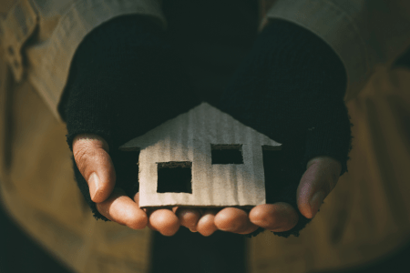 Close up of hands holding a crafted house