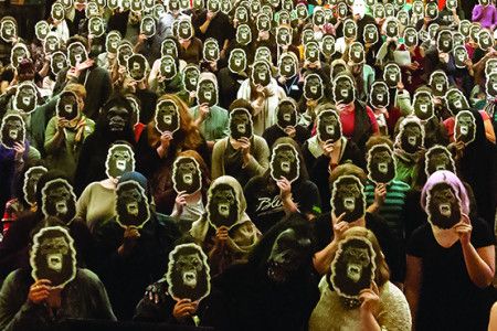 Girls wearing gorilla masks 