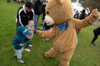 Life size teddy bear dancing with attendees at Keysborough's Big Picnic