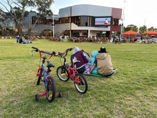 Family enjoying a film at Open Air Movies, Springvale Community Hub