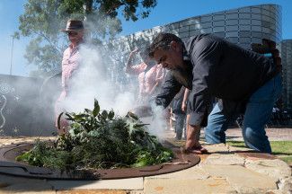 An Elder performing a Smoking Ceremony at the Reconciliation Action Plan Launch 2022