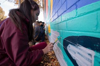 Students painting the Leonard Avenue mural