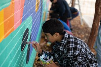 Students painting the Leonard Avenue mural