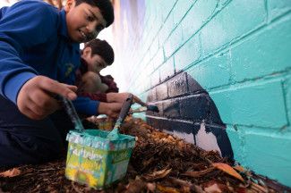 Students painting the Leonard Avenue mural