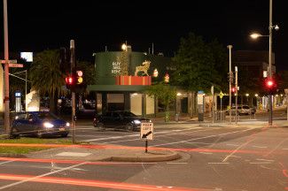 Night view of Christmas decorations above businesses in Dandenong
