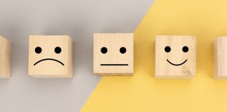 Wooden boxes with smiley and sad faces