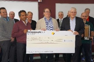 people holding a giant cheque