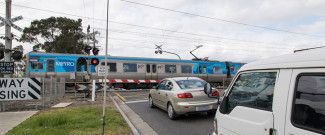 Image of level crossing and cars