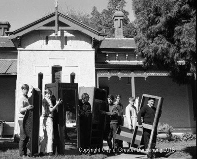 A group of people carrying furniture in a black and white image