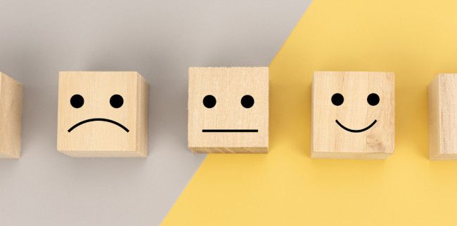 Wooden boxes with smiley and sad faces