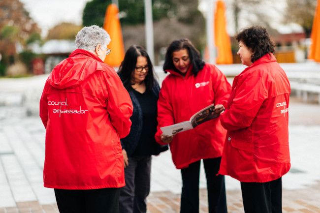 people in red jackets standing in a circle