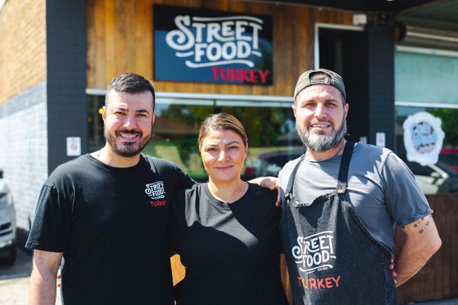 Three people from Street food turkey infront of their business