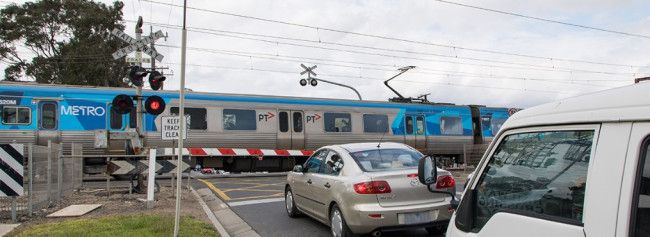 a level crossing with a train going past