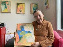 Pauline Mays holding her artwork