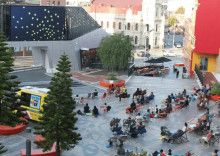 People watching the big screen in Harmony Square