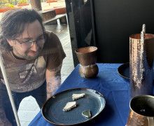 Artwork from Settlement on display on blue cloth.