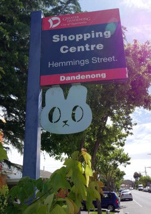 Street sign with sculpture