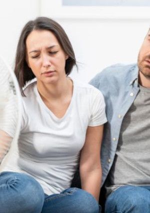 two people sitting in front of a fan