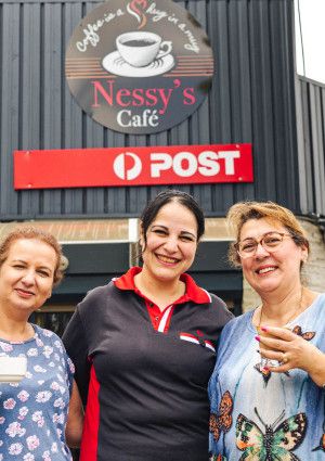 Three ladies standing in front of Nessys Cafe