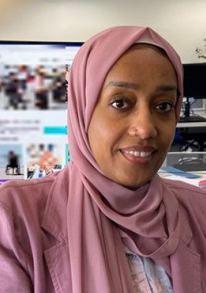 A lady sitting at her desk Manal