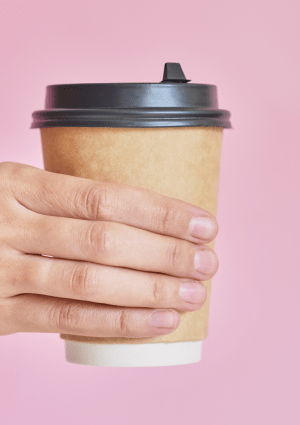 Hand holding a disposable coffee cup